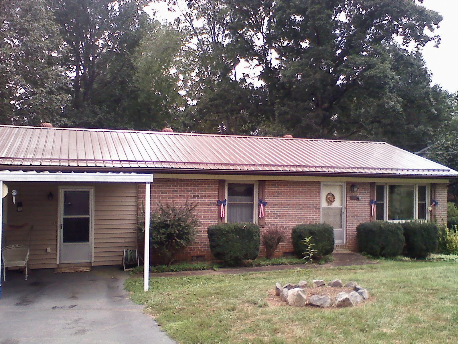Bronze metal roof and carport on a brick ranch home — Roof Repair work by our crew in Larkspur
